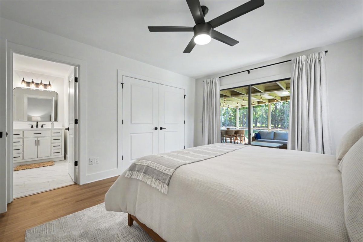 Wake to natural light in this serene bedroom with sliding doors opening to your private patio sanctuary.