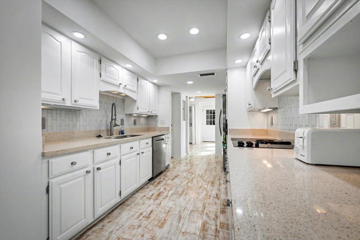 Your bright, spacious kitchen invites culinary adventures with gleaming granite counters, crisp white cabinets, and modern appliances ready for your favorite meals.