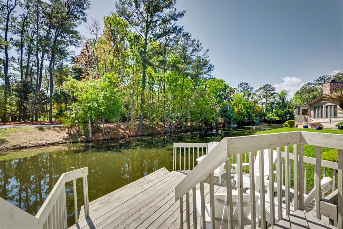 Step onto your private deck overlooking serene waters, surrounded by lush greenery that creates perfect tranquility for morning coffee or evening relaxation.