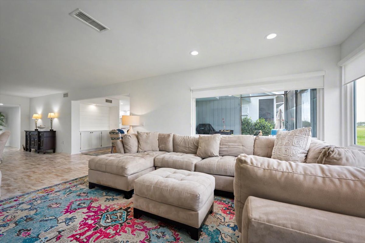 Sink into this plush sectional and unwind in your spacious living room with beautiful natural light streaming through large windows.