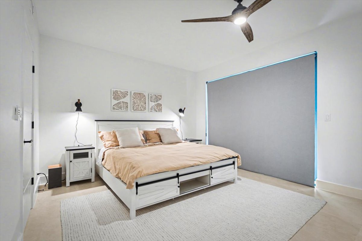 Unwind in your serene bedroom with a plush king bed, gentle ceiling fan breeze, and modern touches creating the perfect retreat.