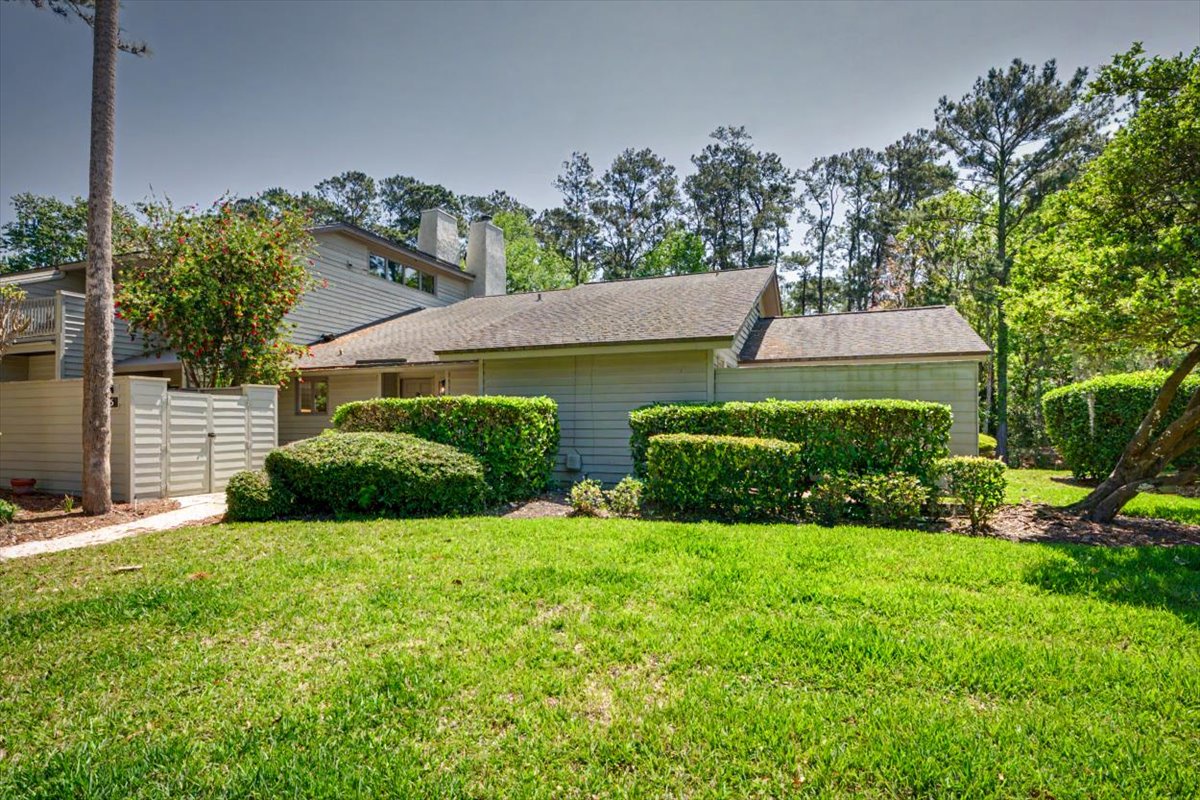 Charming single-story home nestled in a peaceful neighborhood with lush landscaping and mature trees creating a serene retreat setting.