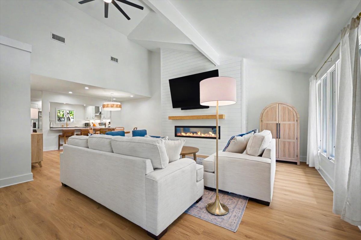 Unwind in this elegant living space where plush seating faces a cozy fireplace, creating the perfect atmosphere for relaxing evenings together.