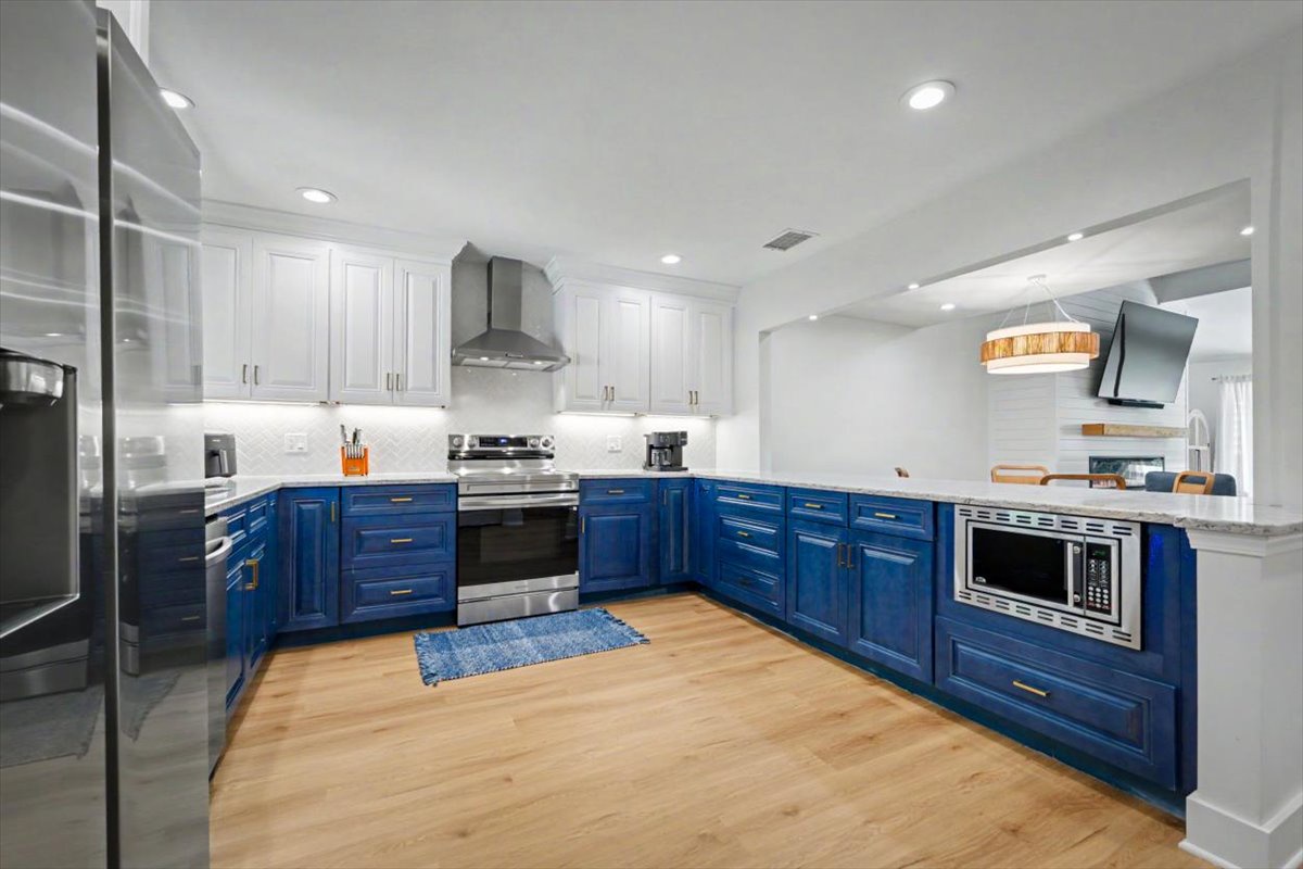 Your spacious gourmet kitchen features stunning two-tone cabinets and premium stainless appliances, perfect for creating memorable meals during your stay.