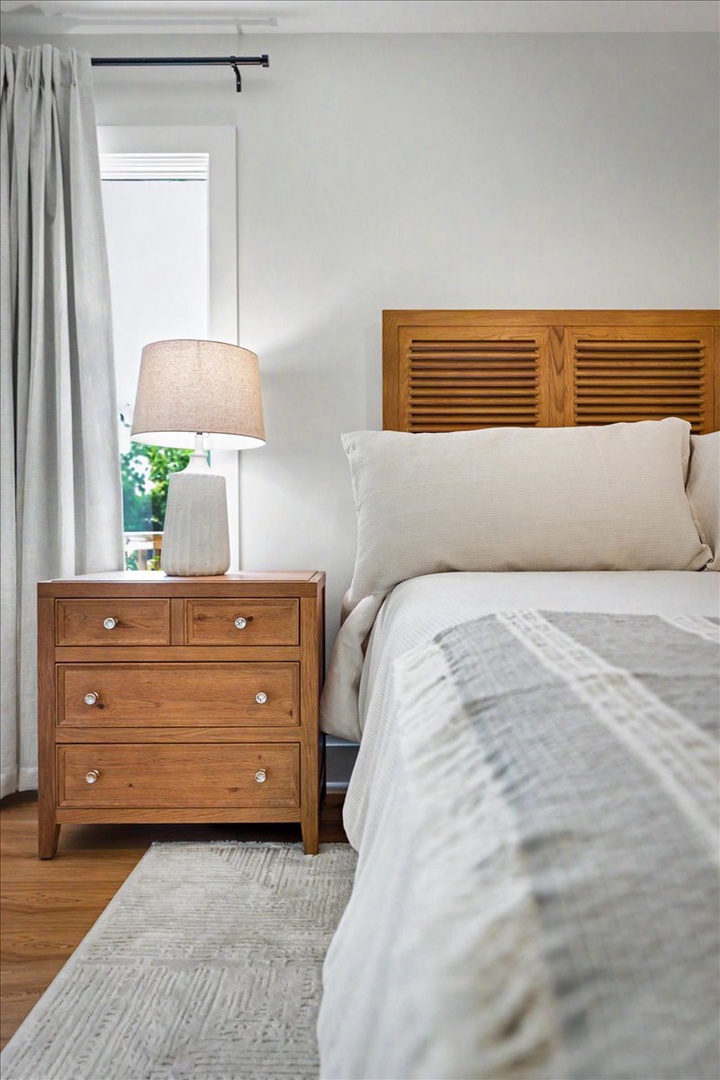Sink into soft linens and warm wood tones in your peaceful bedroom retreat, where restful nights await.