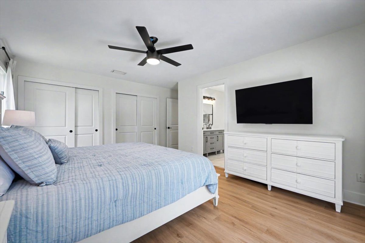 Your spacious bedroom features coastal-inspired linens, modern TV entertainment, and an ensuite bath for ultimate comfort.