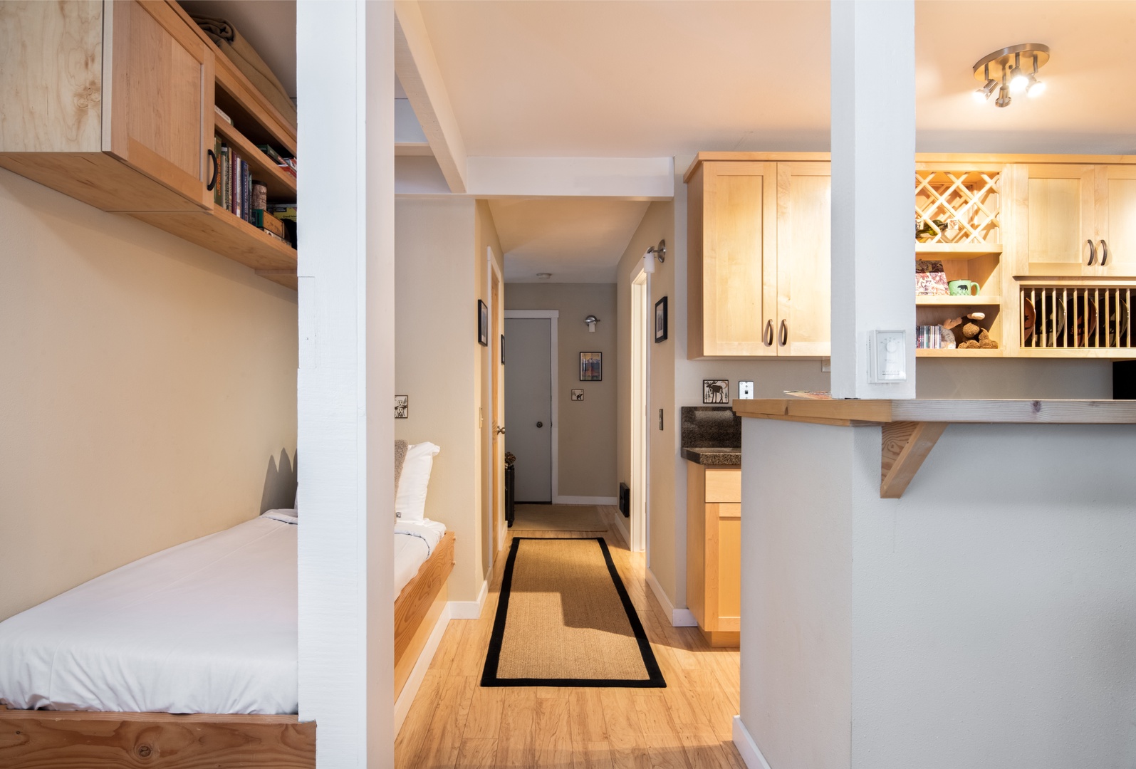 Hallway looking into Kitchen with twin bed