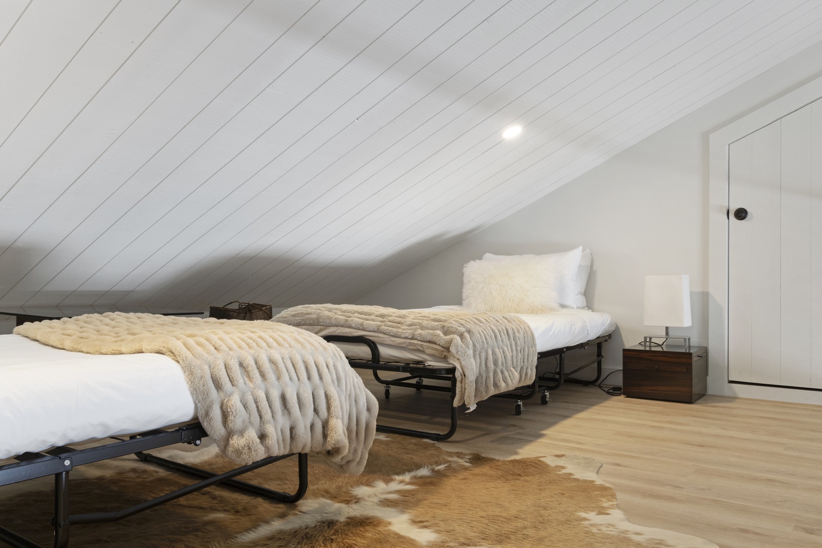 Loft with 2 cots - please note that the ceiling is sloped