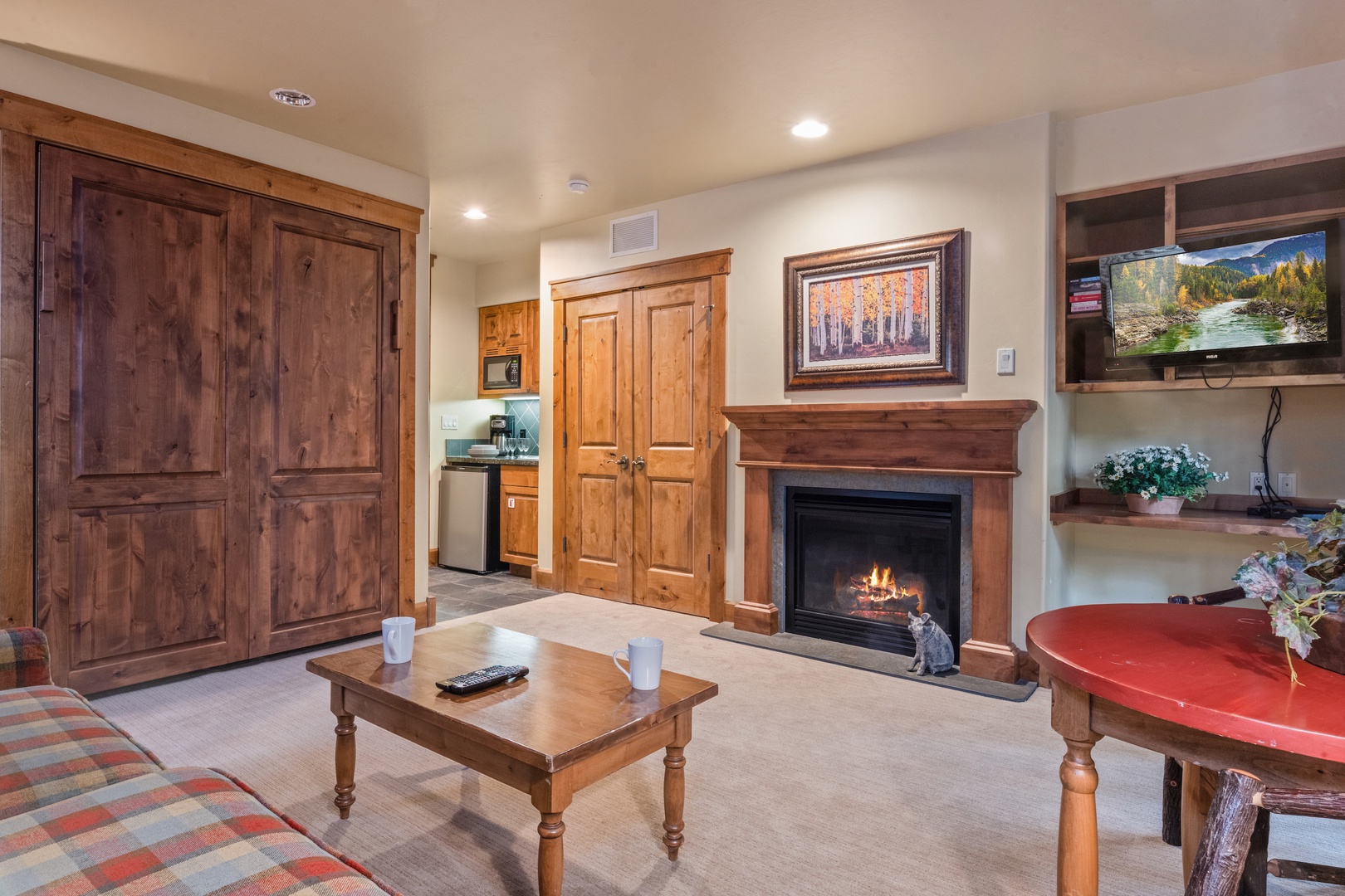Living room with Gas fireplace. Please note this space doubles as a guest room with murphy bed