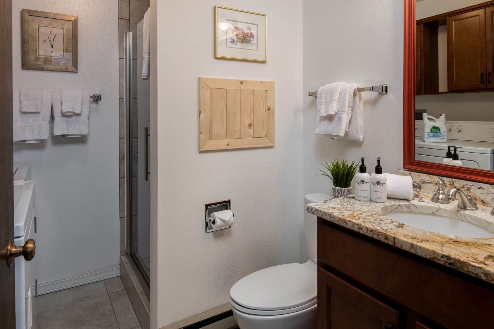 First floor bathroom with a shower and washer/dryer