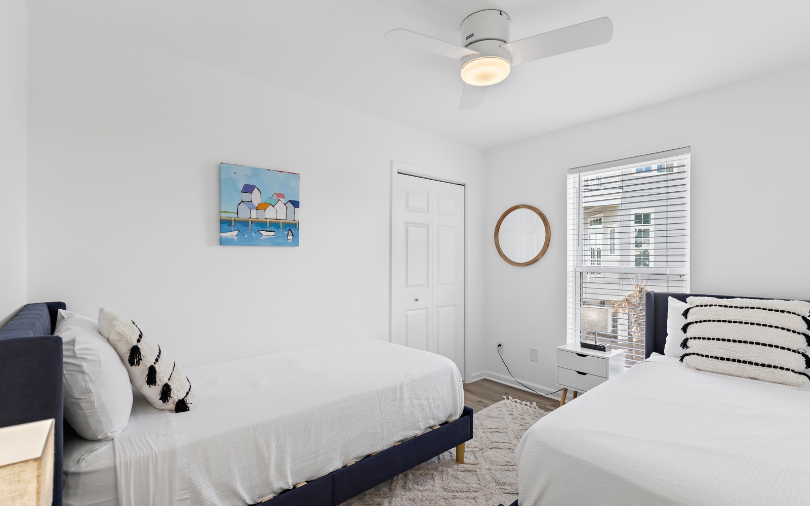 Relax in your bright, airy bedroom with two comfortable beds, stylish coastal decor, and a ceiling fan to keep you cool.