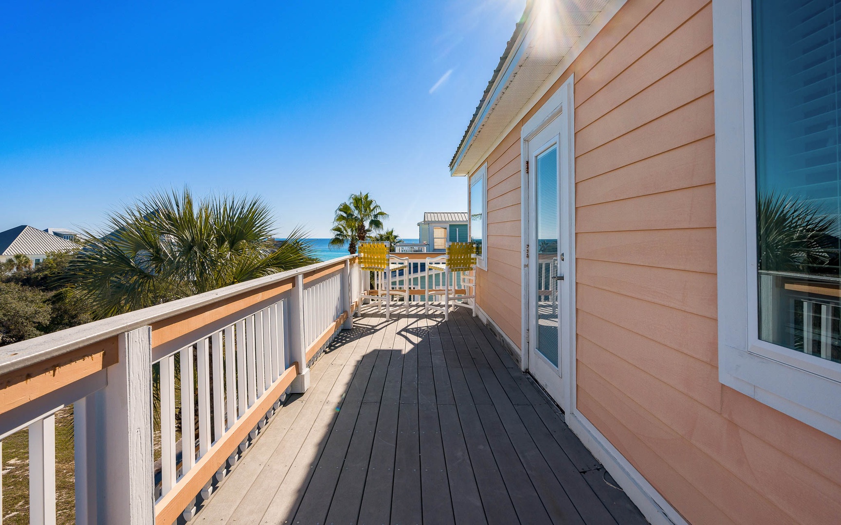 Step onto your private deck where palm trees frame sparkling ocean views and coastal breezes invite endless relaxation.