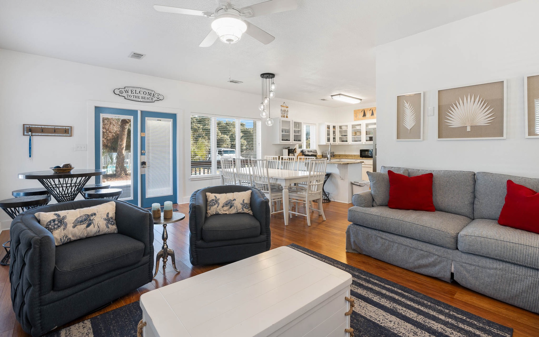 Relax in this bright, coastal-inspired living space where comfortable seating and an open layout create perfect gathering spots for your group.