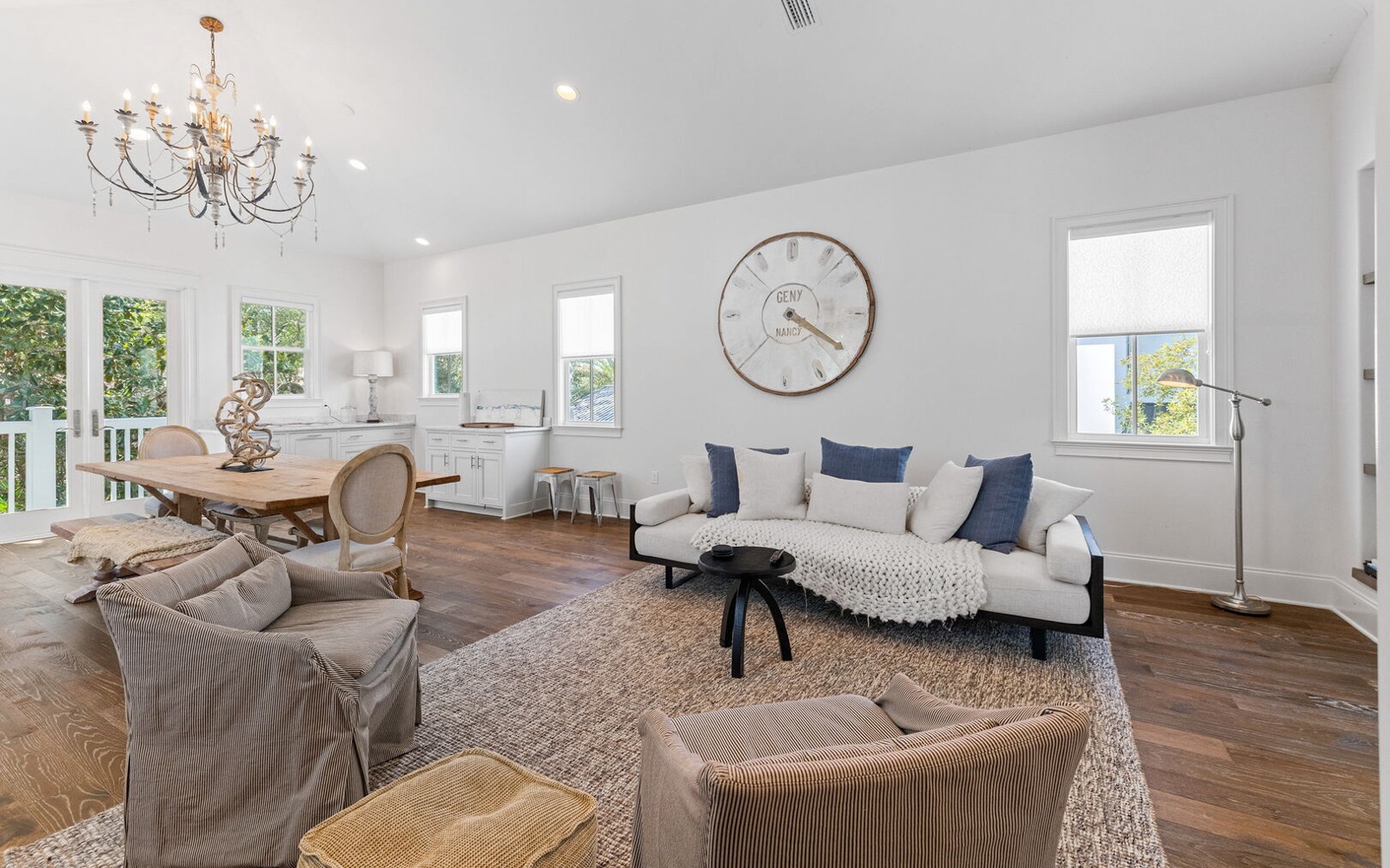 Unwind in this bright, elegant living space with plush seating and gleaming hardwood floors that invite barefoot comfort.