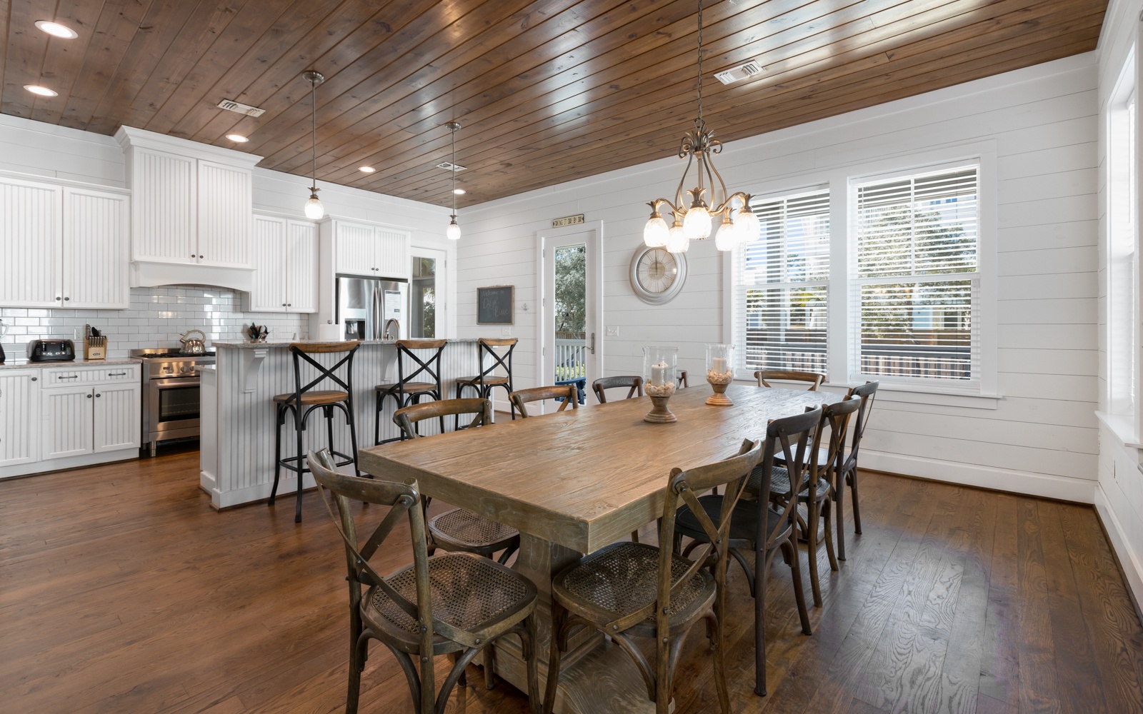 Gather around this stunning farmhouse dining table where your family meals become cherished memories beneath the warm wood ceiling.