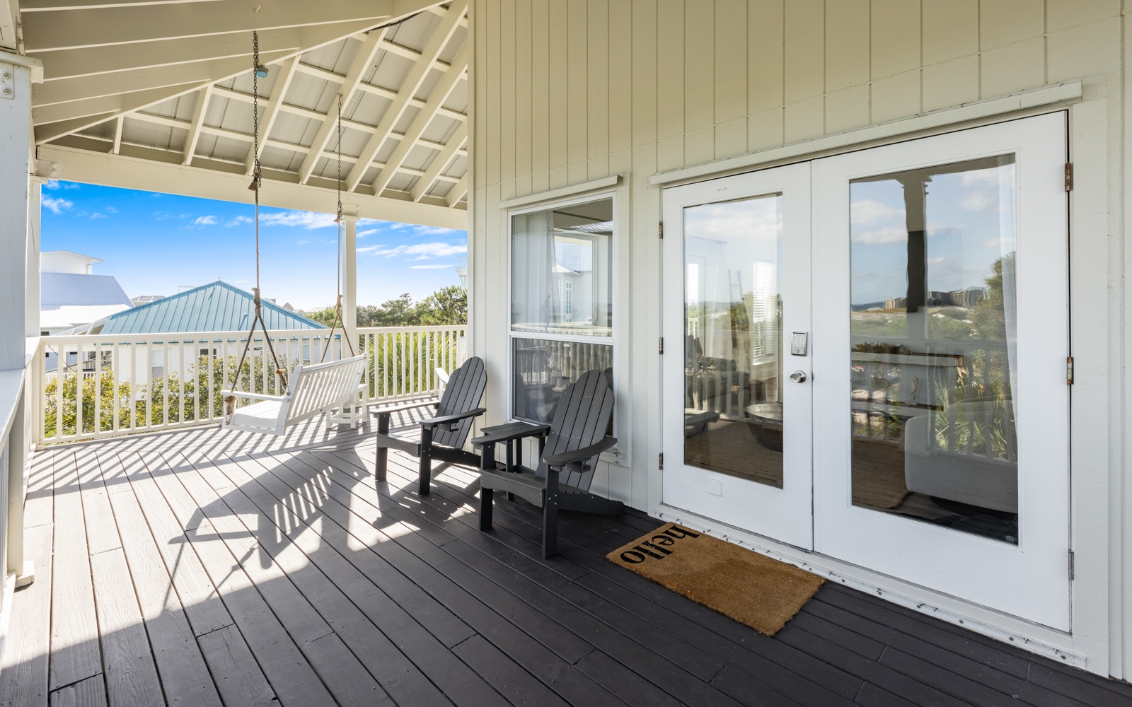 Step onto your private deck where morning coffee tastes better with ocean breezes and a porch swing waiting for lazy afternoons.
