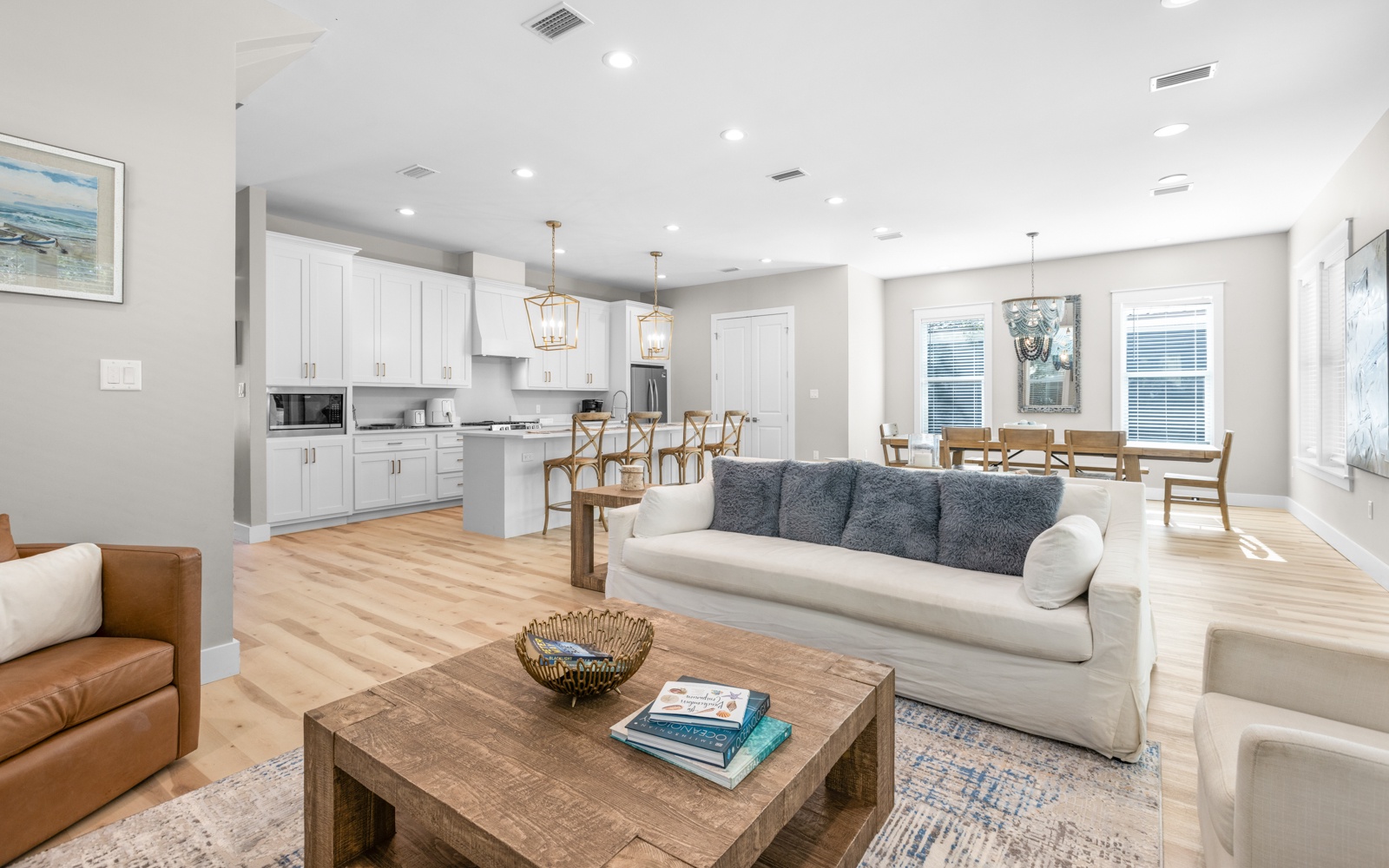 Relax in your bright open-concept space where modern comfort meets coastal charm, with soaring ceilings and natural light streaming through.