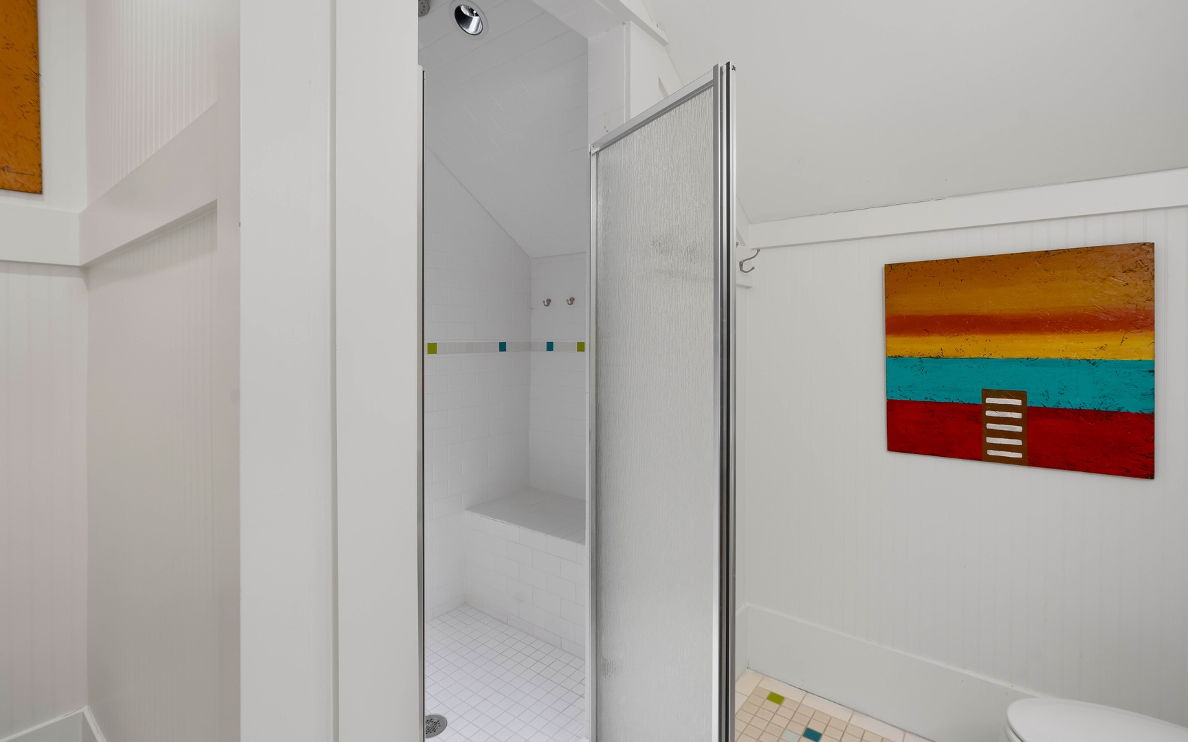 Step into your bright, modern bathroom featuring a spacious glass-enclosed shower and vibrant artwork that adds personality to your morning routine.
