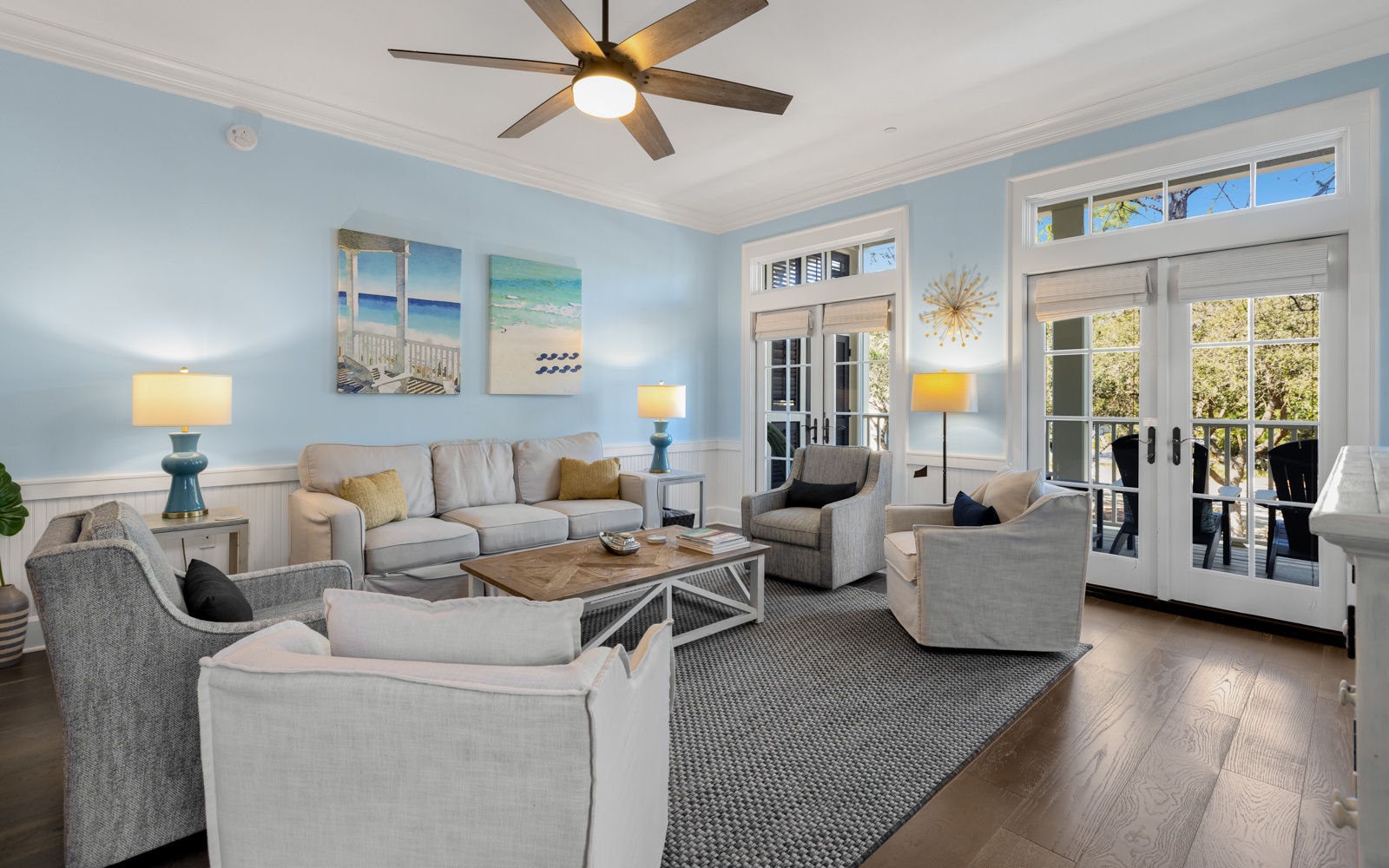 Relax in your beautifully appointed living room with coastal charm, plush seating, and French doors opening to your private balcony.