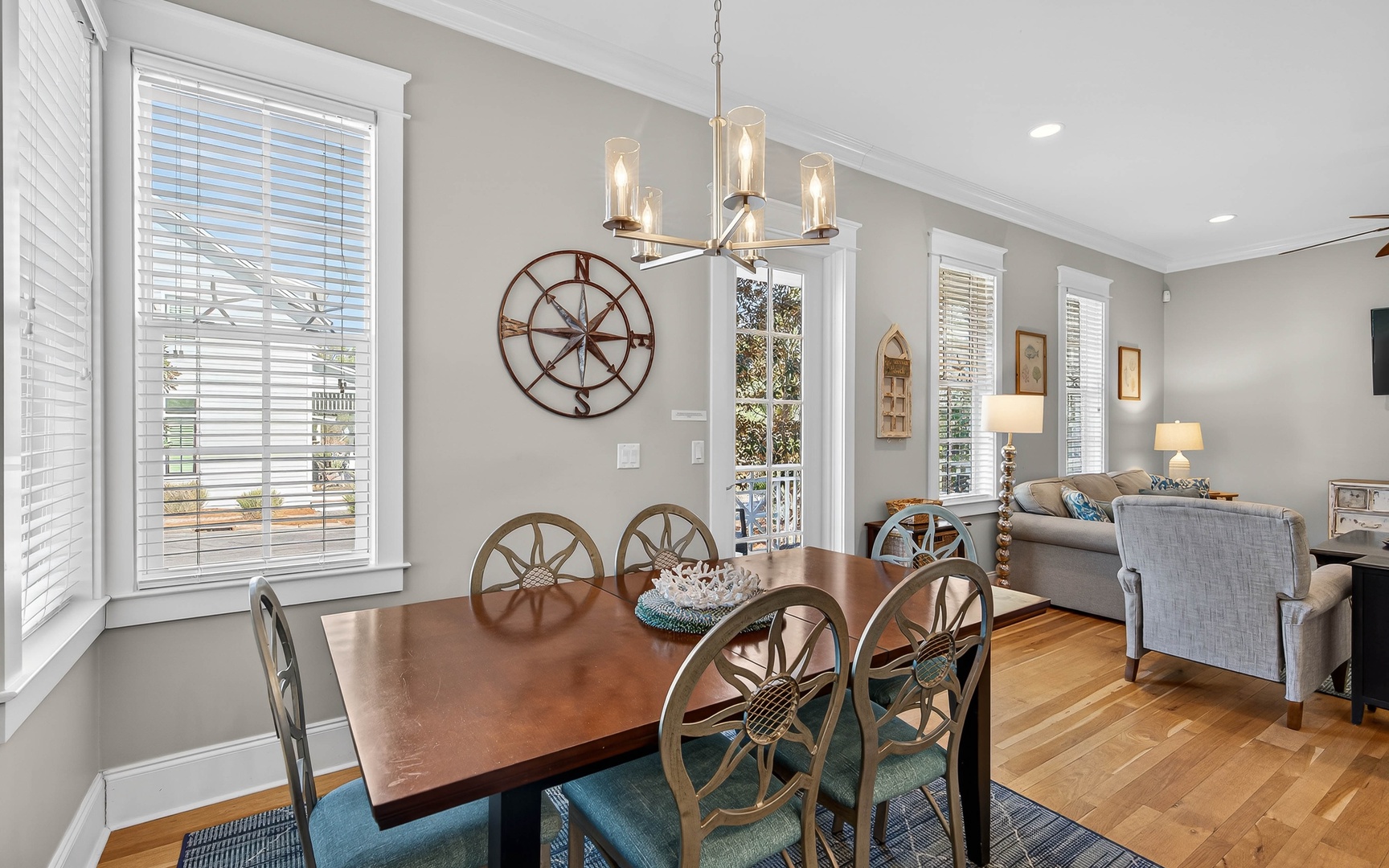 Gather around your elegant dining table where nautical touches and warm lighting create memorable meals together.