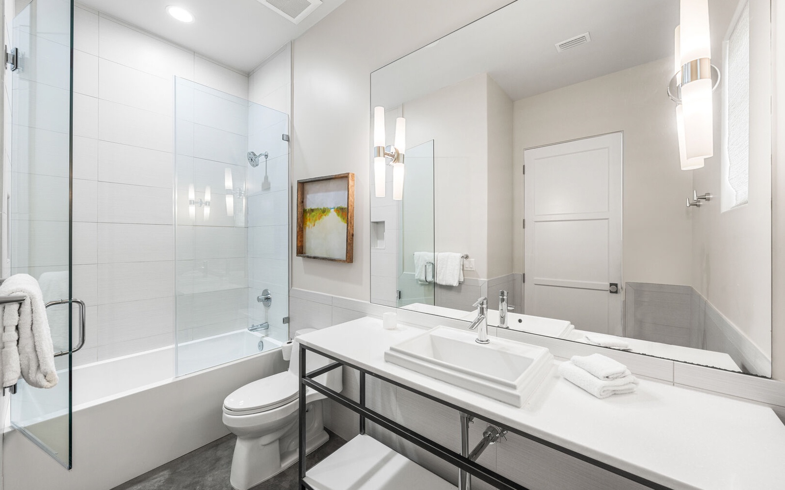 Step into your pristine sanctuary featuring crisp white marble, a spacious glass-enclosed tub, and modern fixtures that create the perfect retreat.