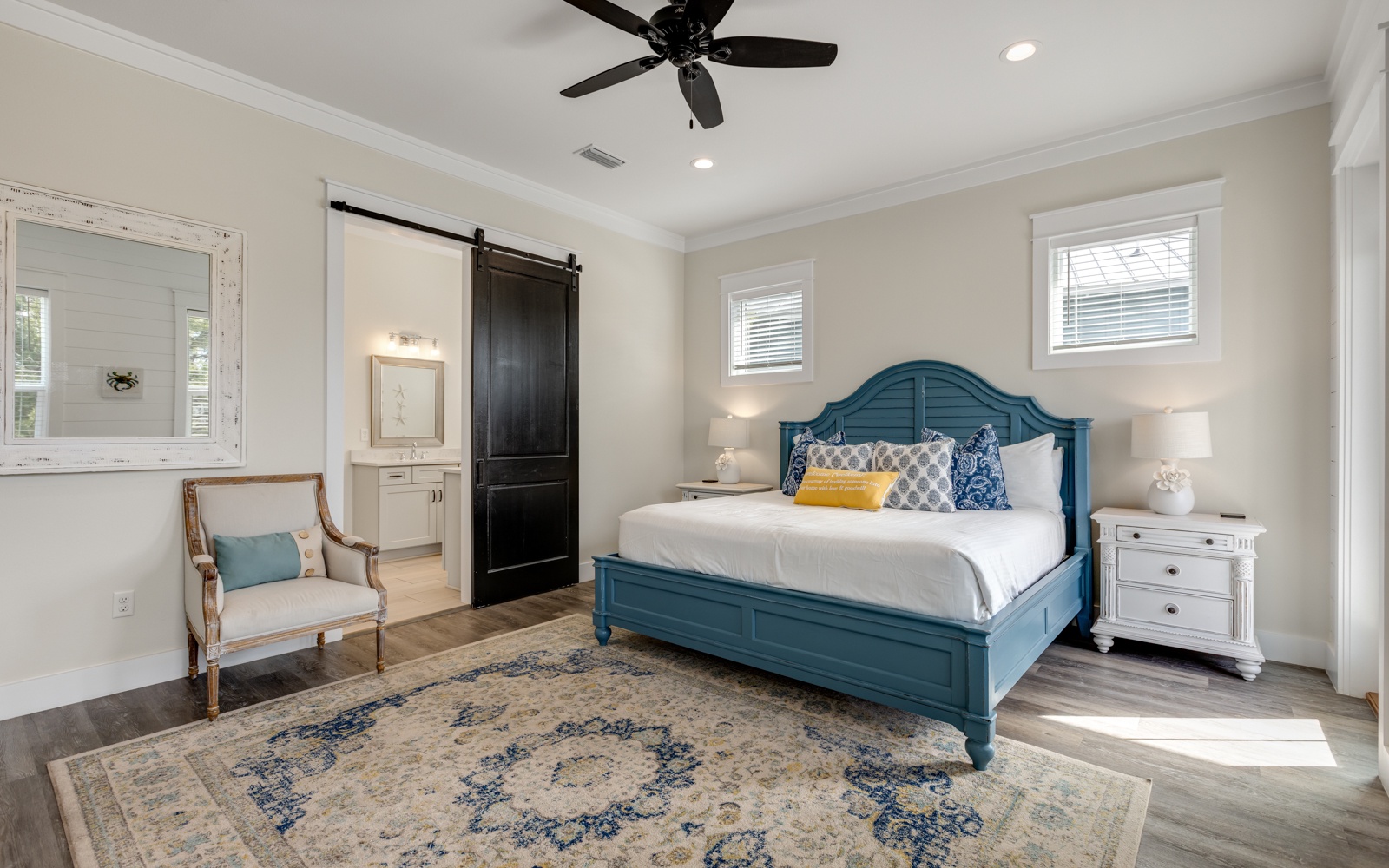 Your elegant bedroom retreat features a stunning teal bed, cozy seating nook, and spa-like en-suite for ultimate relaxation.