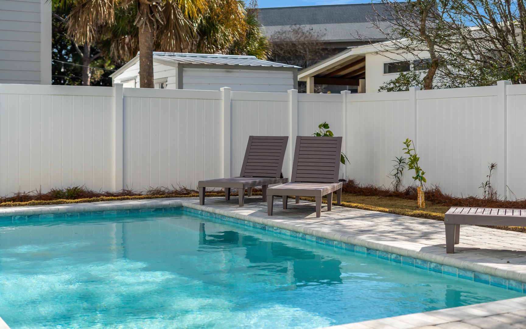 Soak up sunshine on your private poolside loungers, surrounded by tropical palms and complete privacy.