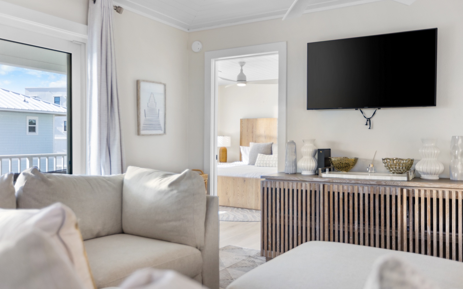Sink into plush seating while enjoying your favorite shows on the wall-mounted TV, with stylish storage beneath and natural light streaming in.