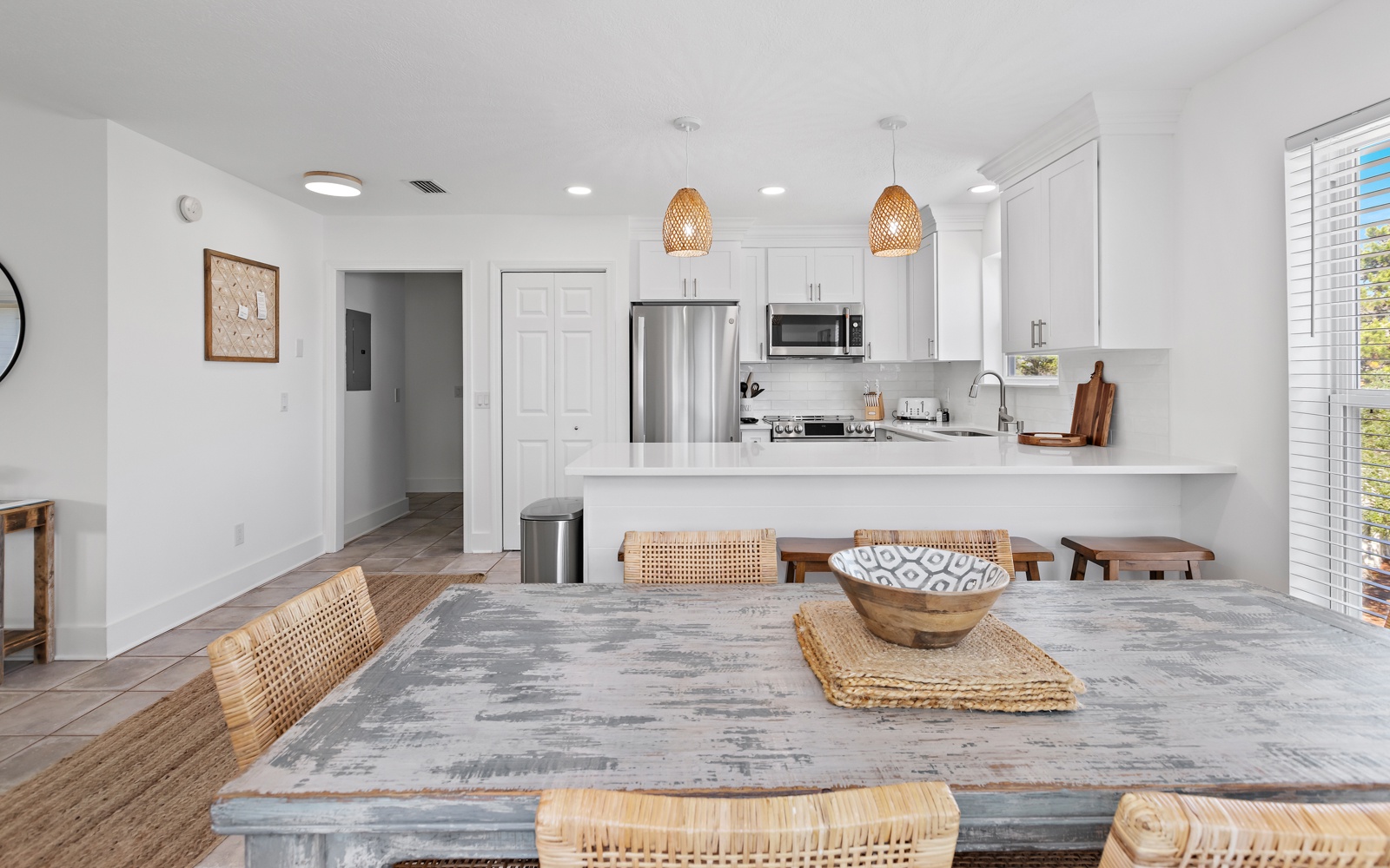 Gather around this beautiful dining table that flows seamlessly into your fully-equipped modern kitchen, perfect for cooking and sharing meals together.
