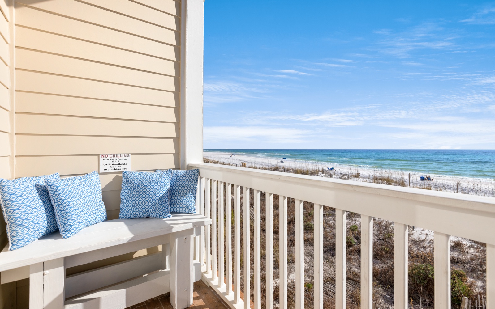 Beachfront balcony offers stunning ocean views and comfortable seating for your perfect coastal getaway.