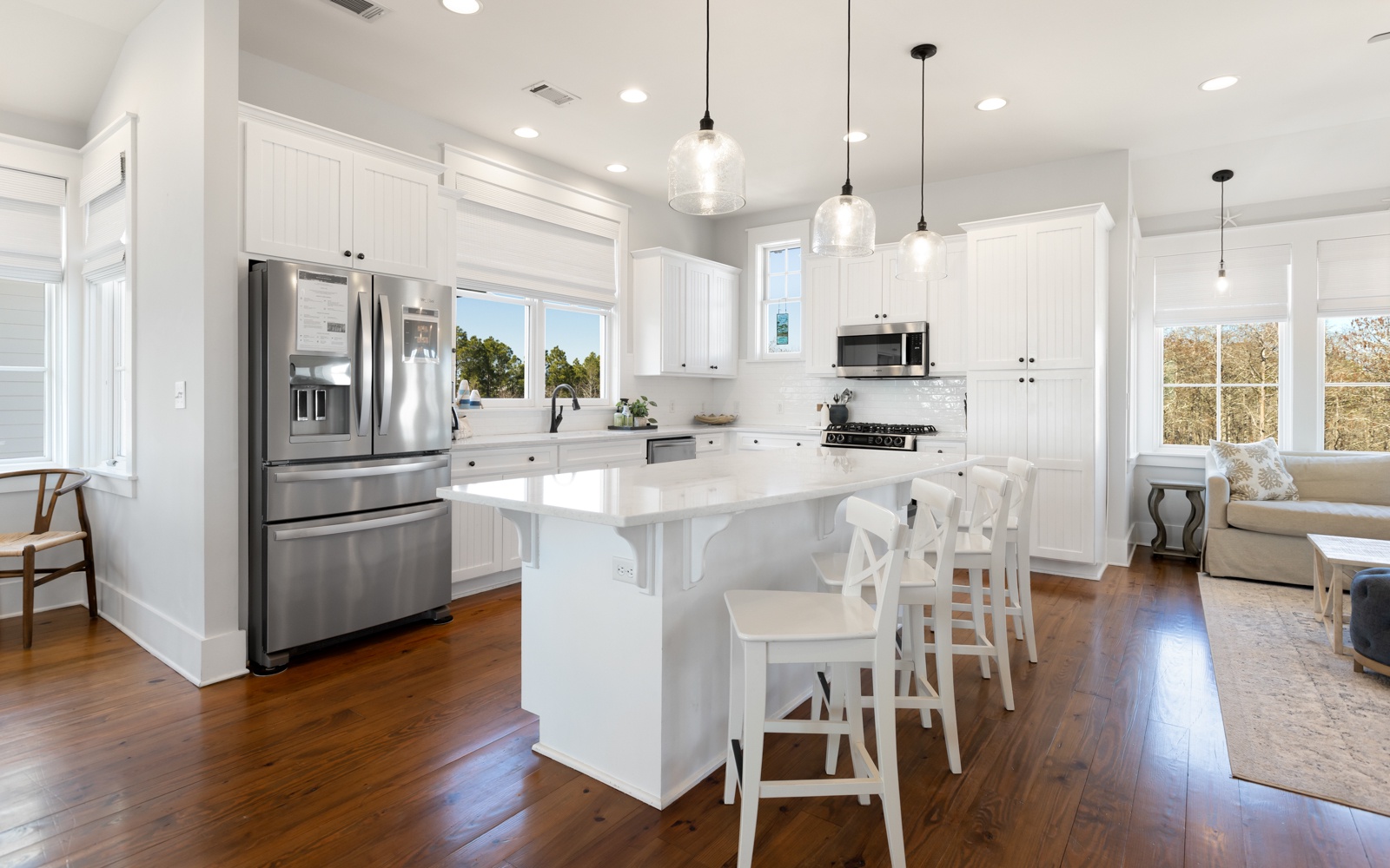 Your spacious kitchen features gleaming white cabinets, stainless appliances, and a breakfast bar where you can start mornings with coffee.
