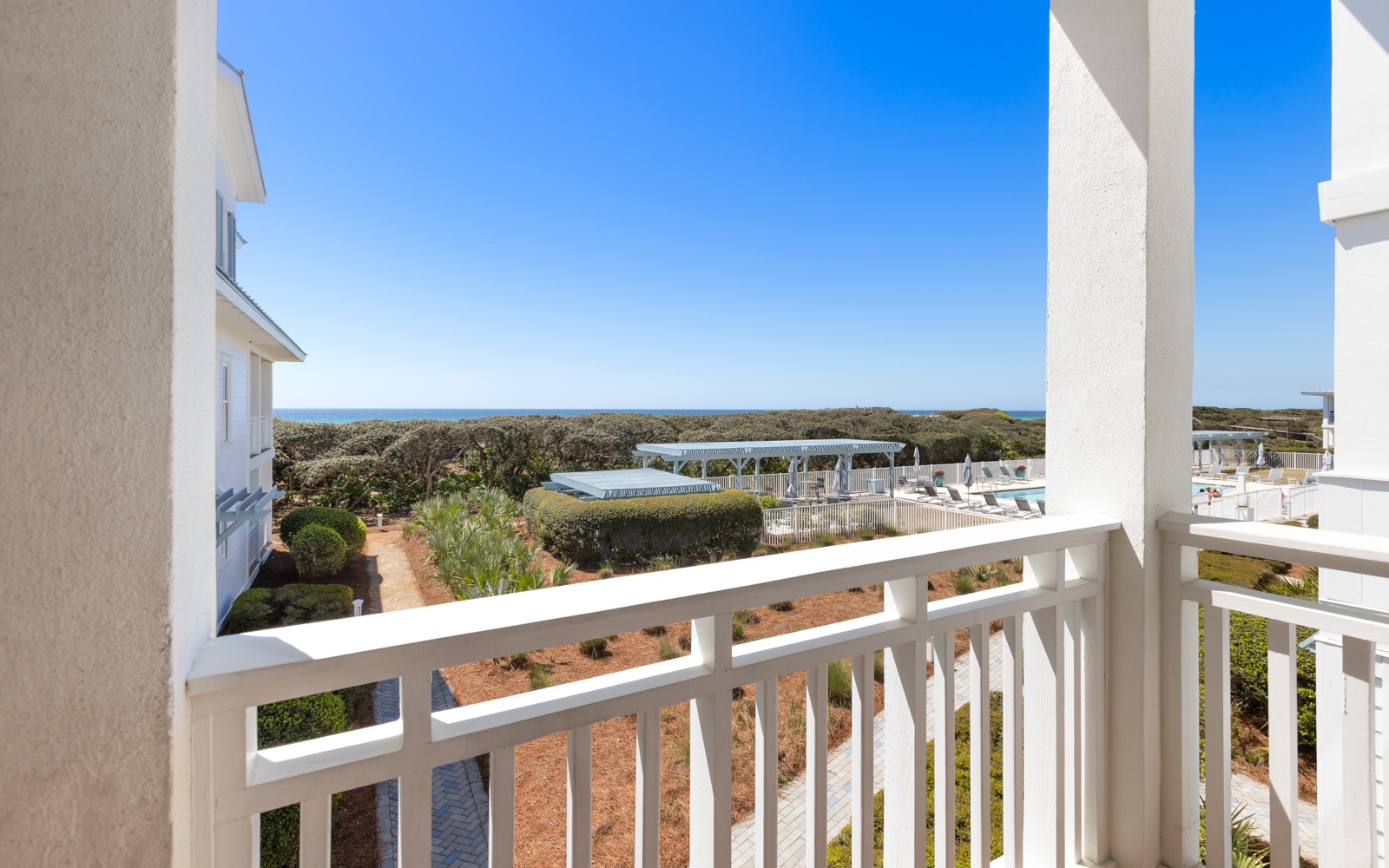 Step onto your private balcony and soak in stunning views of the sparkling pool and distant ocean horizon.