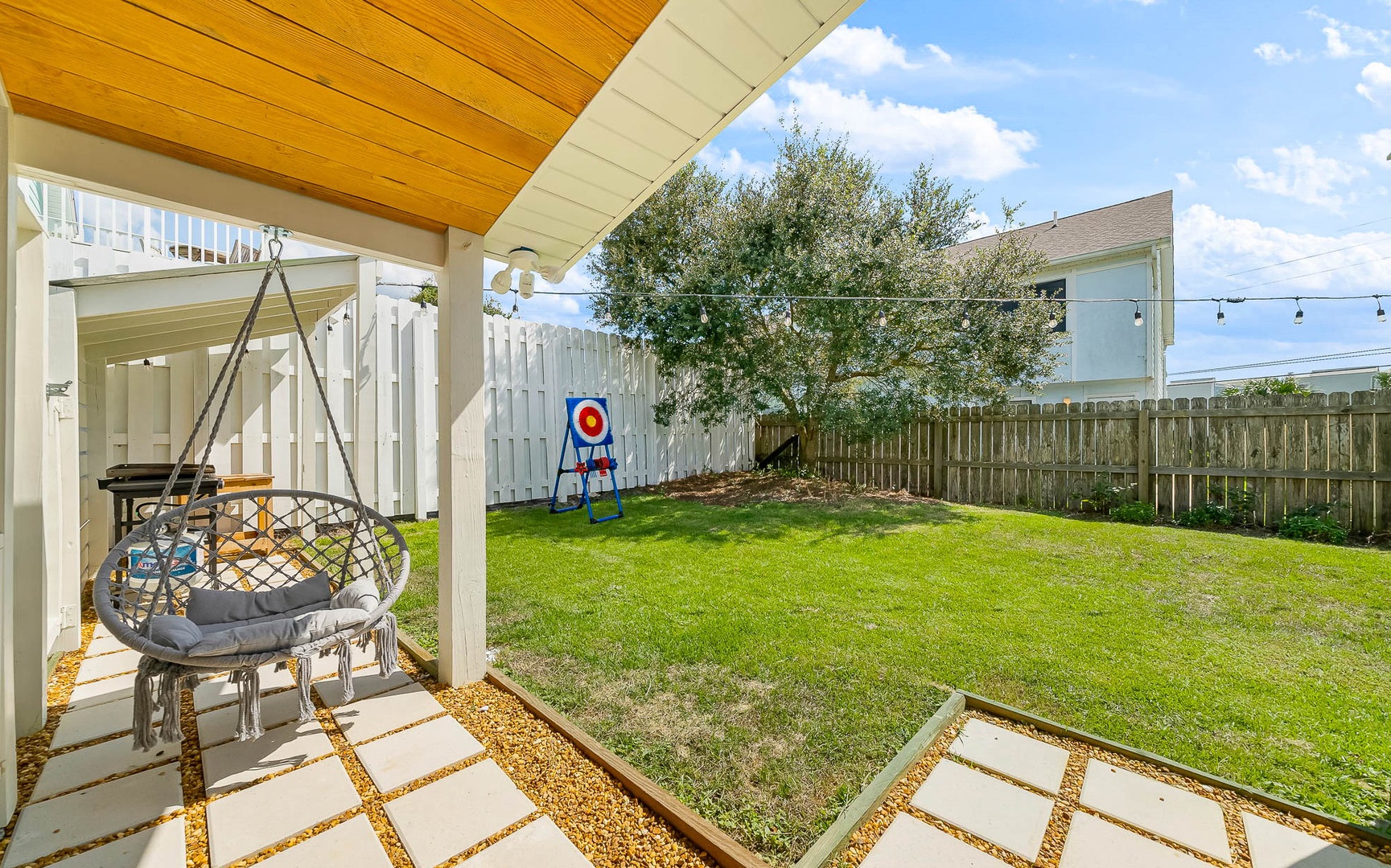Unwind in your covered patio swing while kids play in the spacious, fenced backyard complete with playground equipment.