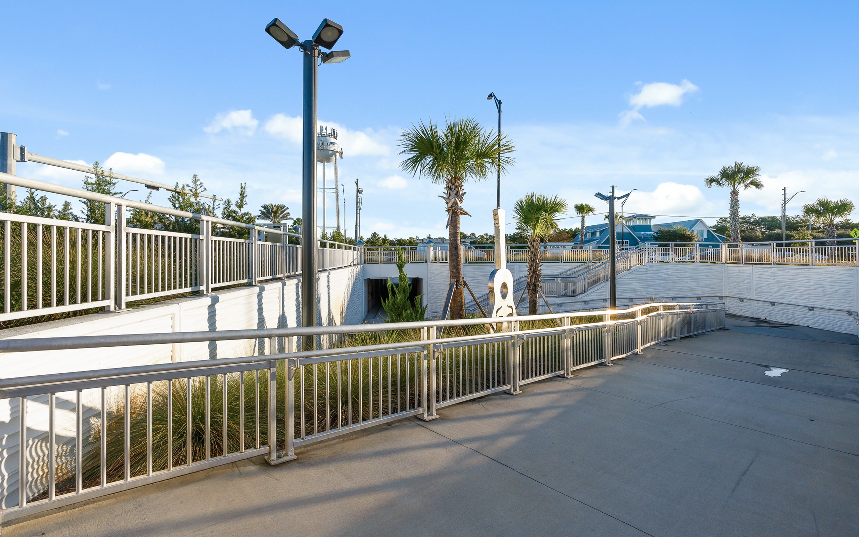 Elevated outdoor facility with tropical palms and scenic views of the surrounding coastal area.