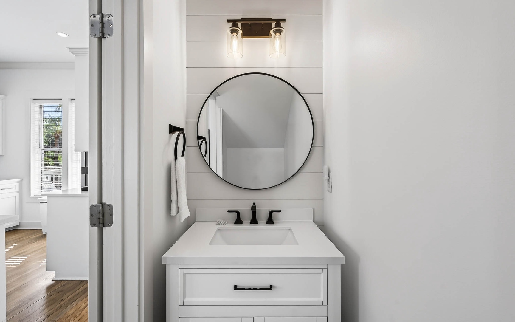 Step into your stylish bathroom featuring a sleek round mirror, elegant vanity, and modern fixtures that create the perfect morning routine space.