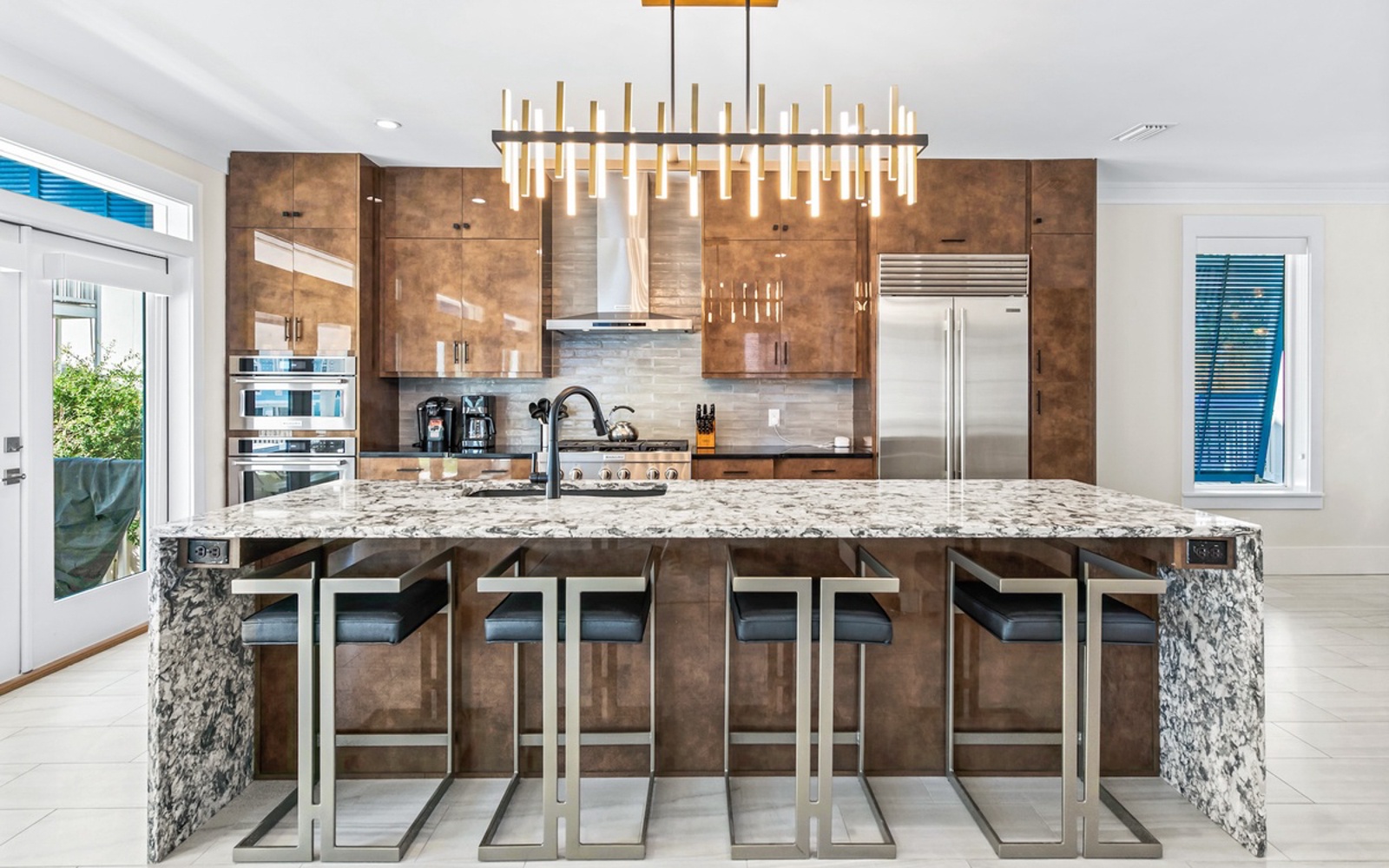 Gather around this stunning granite island where warm wood meets modern design, perfect for your morning coffee or evening conversations.