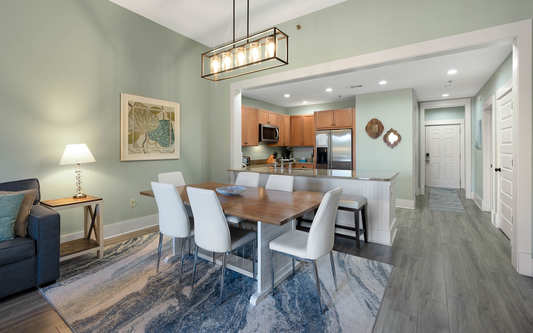 Your elegant open-plan dining and kitchen awaits with modern fixtures, warm lighting, and space for memorable meals together.