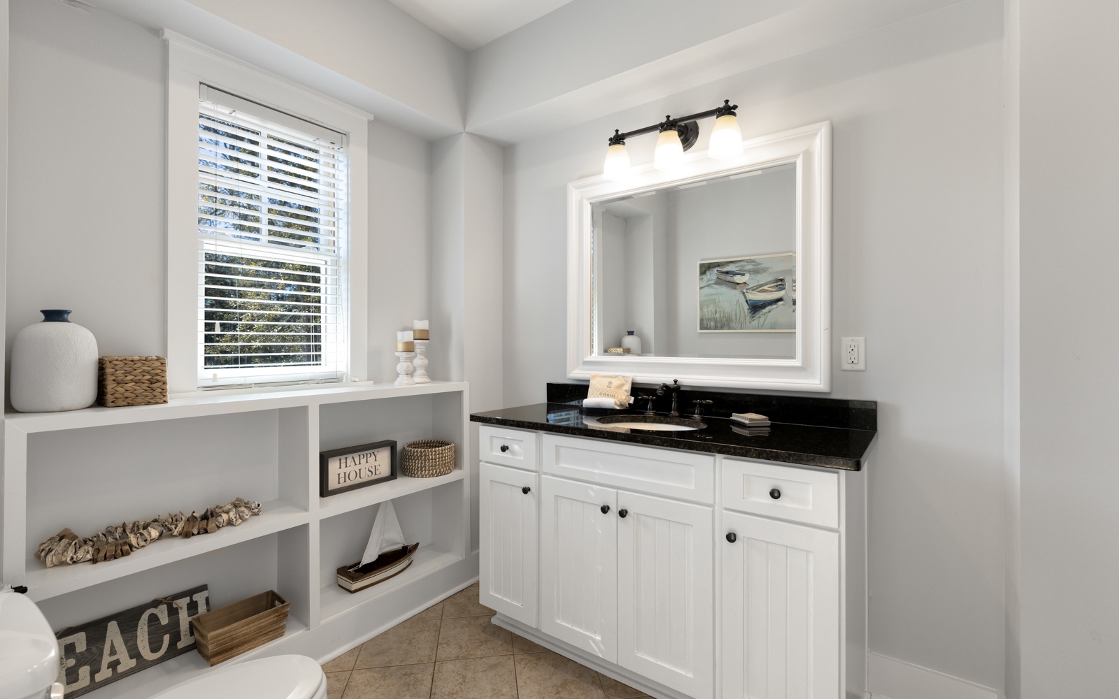 Freshen up in your elegant bathroom featuring custom cabinetry, granite countertops, and thoughtful coastal touches that make every morning feel like a retreat.