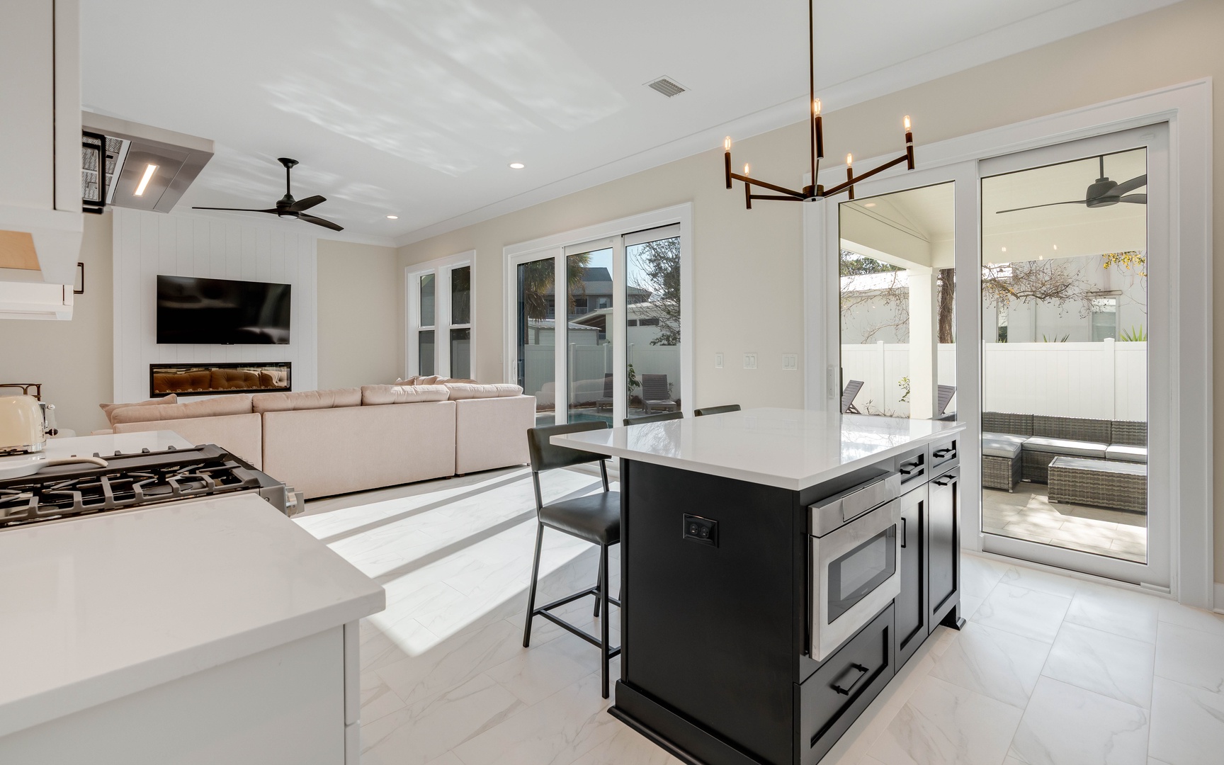 Your modern open-plan sanctuary seamlessly blends kitchen, dining, and living spaces, with sleek surfaces and large windows flooding the area with natural light.