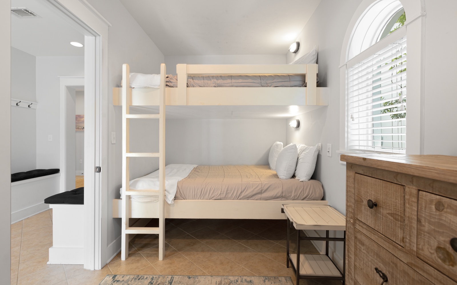 Your cozy bunk room offers space-saving comfort with natural wood details and bright windows to start your day refreshed.