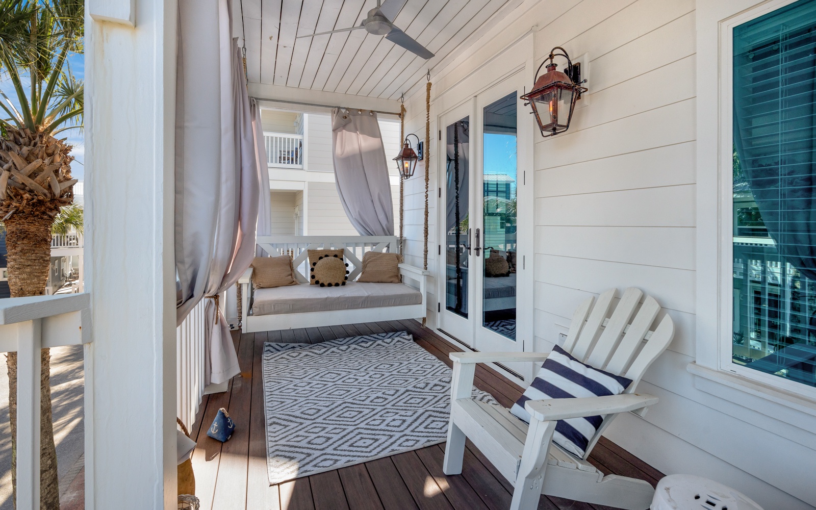 Your private balcony retreat features a dreamy daybed with flowing curtains and cozy seating perfect for morning coffee or evening relaxation.