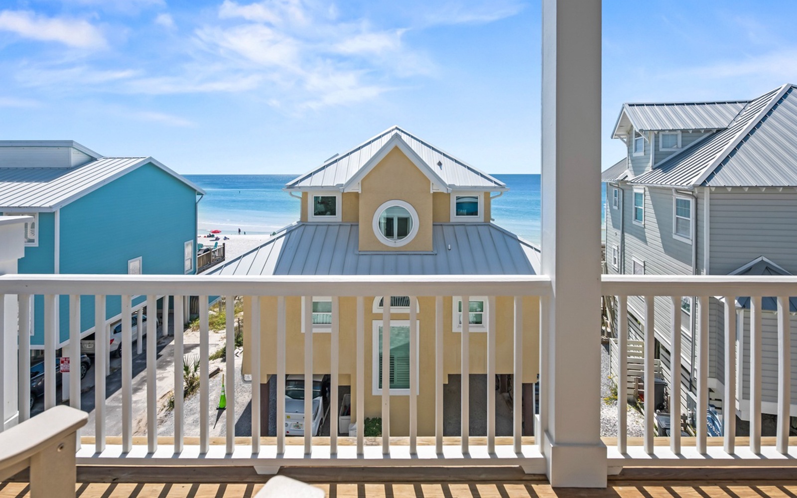 Step onto your private balcony and soak in stunning beach views with colorful coastal homes dotting the pristine shoreline below.