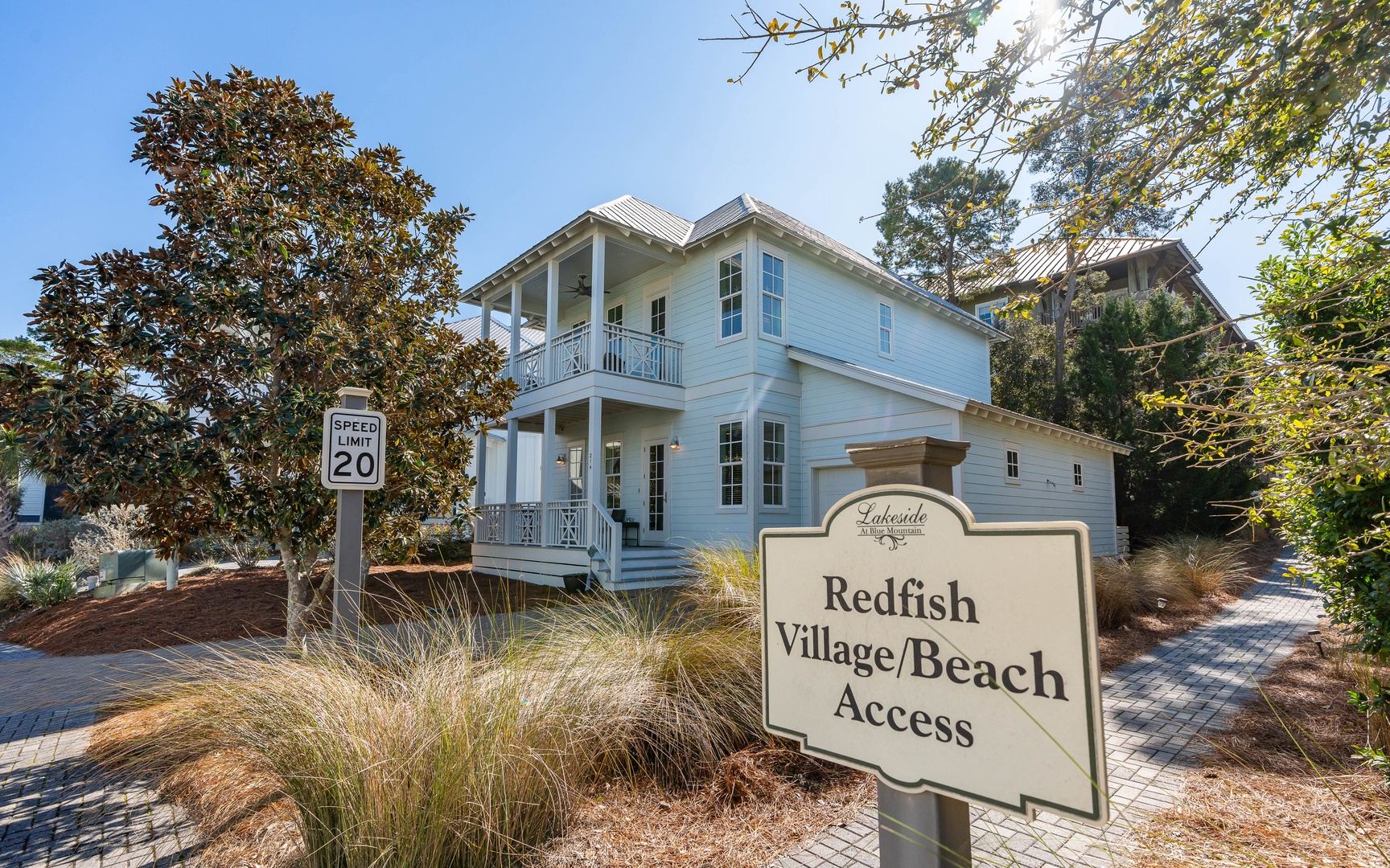 Charming beach cottage with lakeside community access, featuring classic coastal architecture and peaceful neighborhood setting.