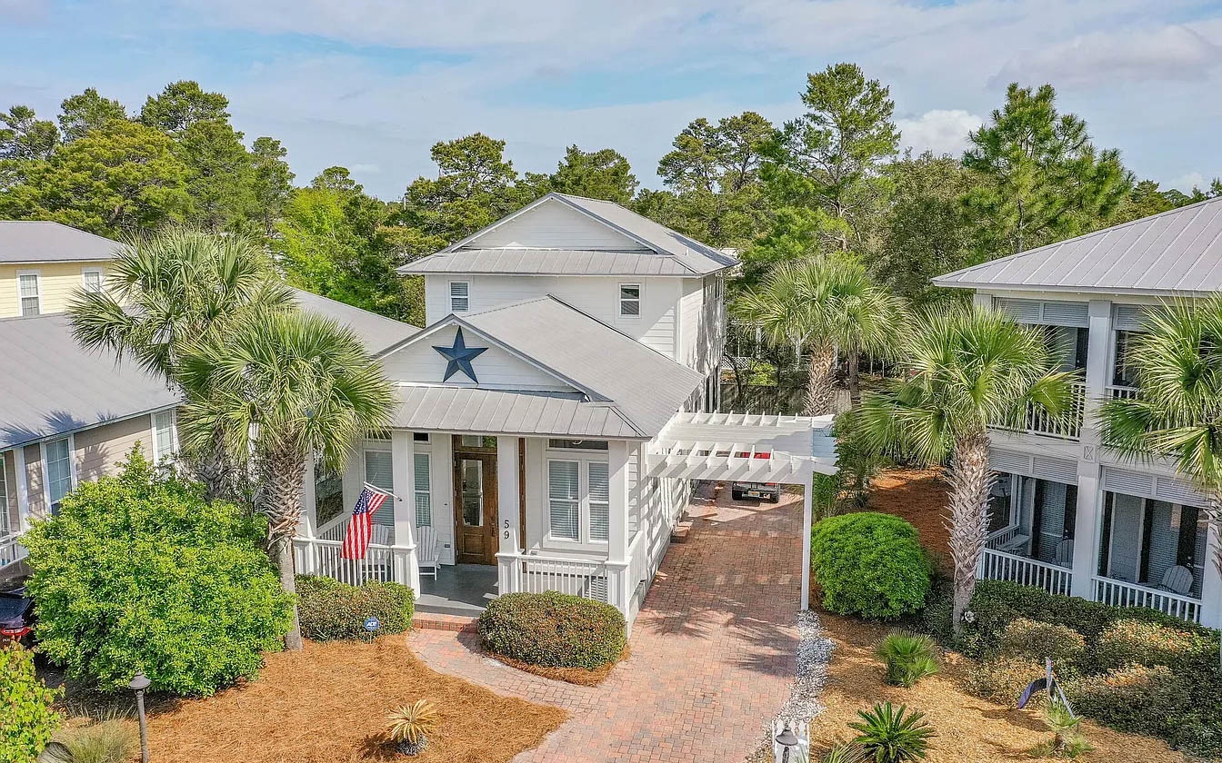 Charming coastal property with tropical landscaping and palm trees nestled in a peaceful residential community.