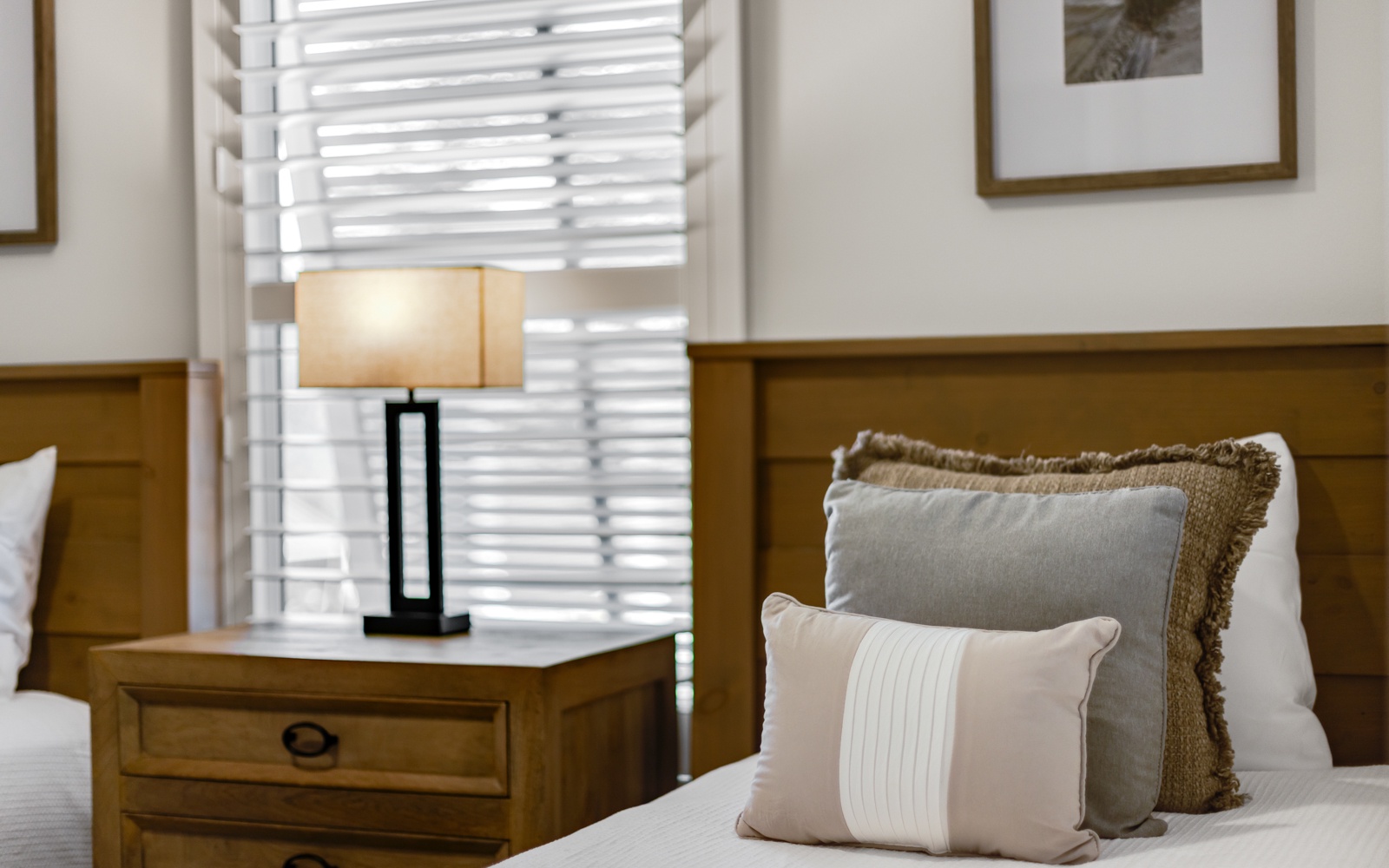 Sink into plush pillows and soft linens in your peaceful bedroom retreat, where warm lighting creates the perfect ambiance for relaxation.