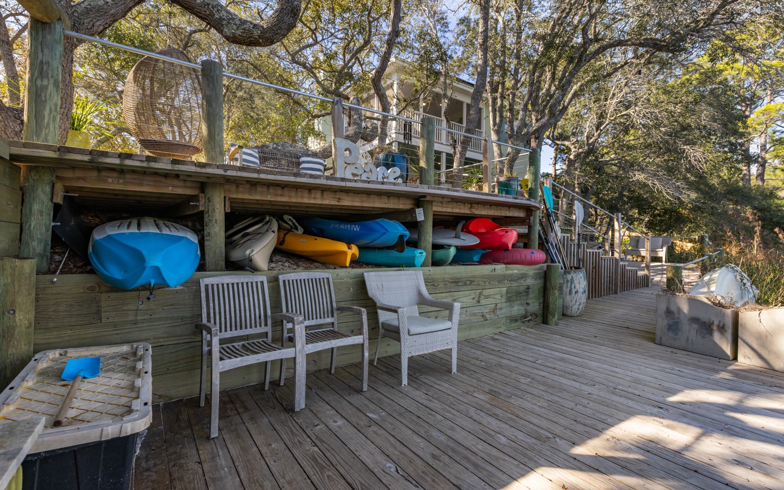 Your private waterside deck awaits with kayaks ready for adventure and cozy seating to watch the day unfold over the water.