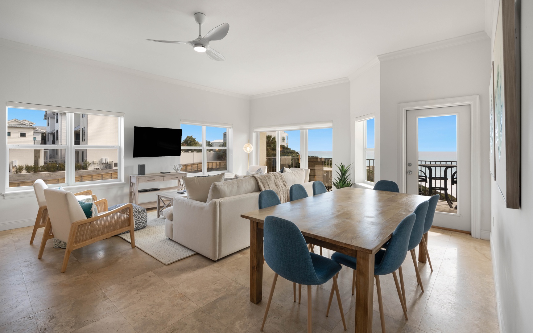 Relax in your bright, open living space where modern comfort meets coastal charm, with dining for eight and balcony access.