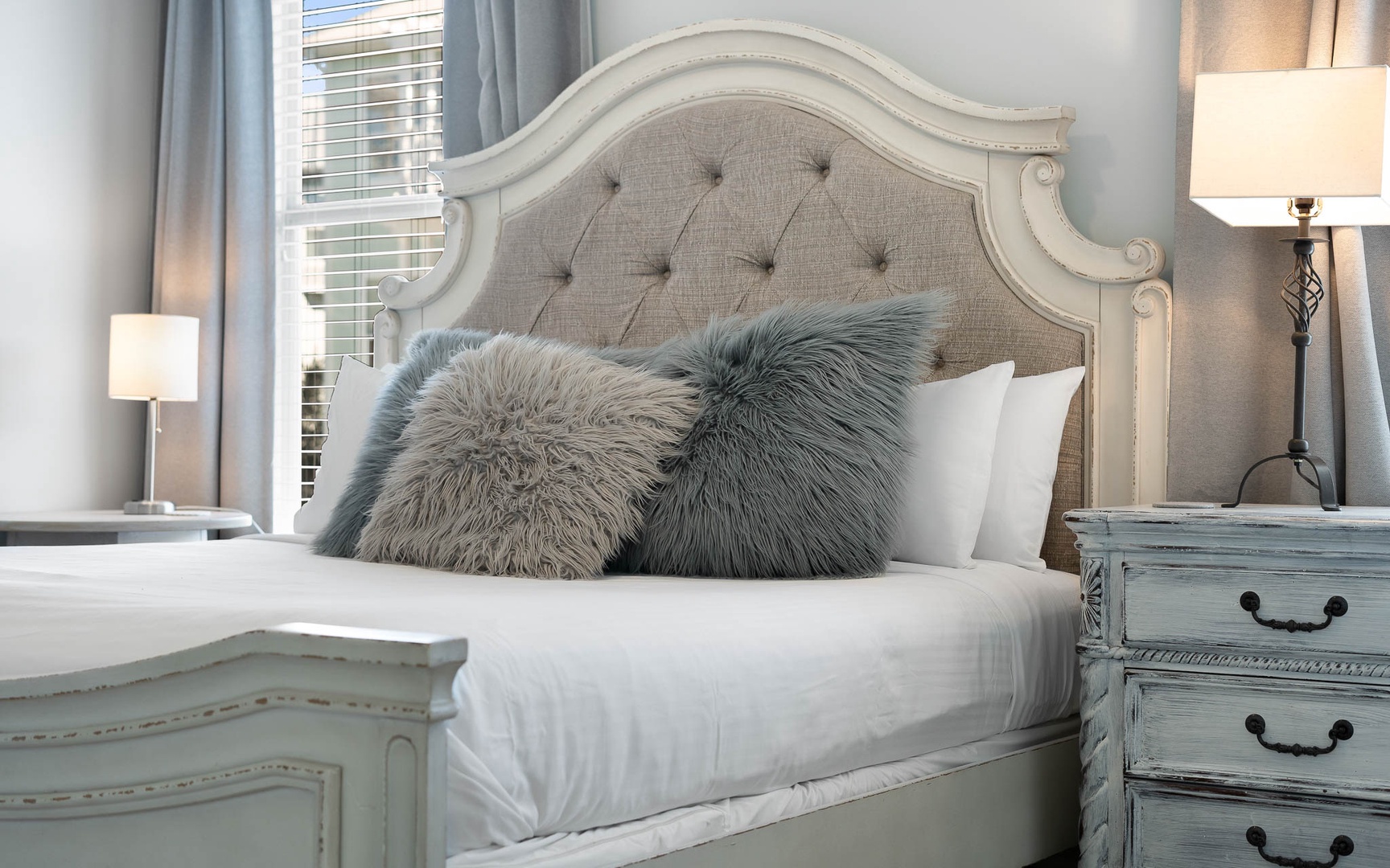 Sink into the plush linens and fluffy pillows of your elegantly appointed bedroom, where soft lighting creates the perfect ambiance for rest.