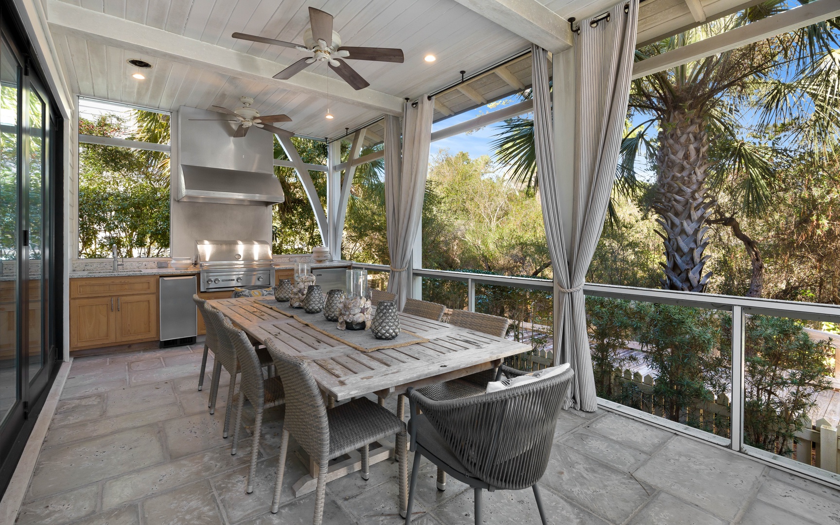 Your screened outdoor kitchen and dining space offers tropical views and comfortable seating for memorable meals together.