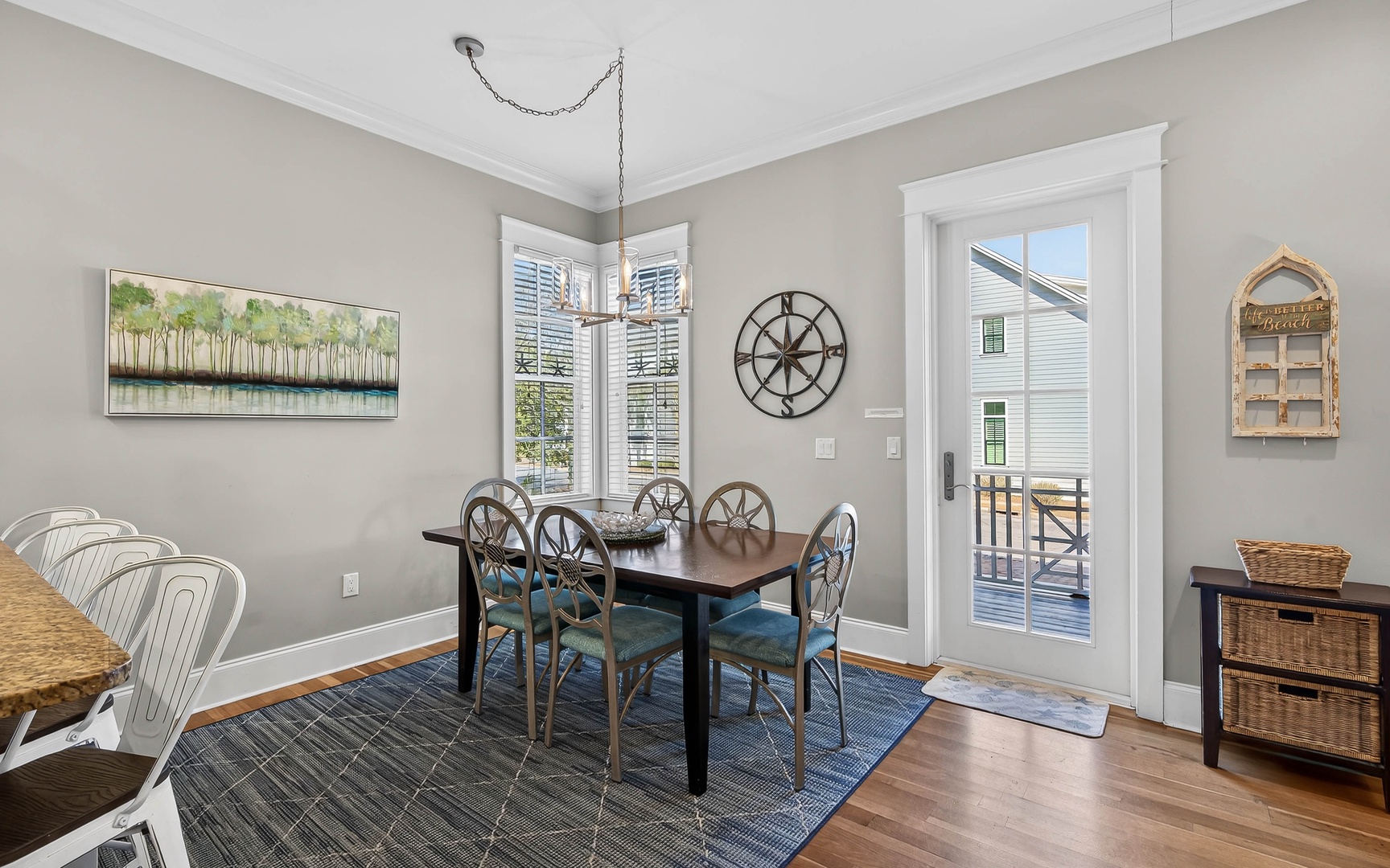 Your elegant dining room invites memorable meals with stylish coastal decor and French doors opening to your private balcony.